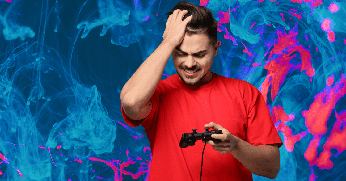 A young man looks upset while holding a video game controller.