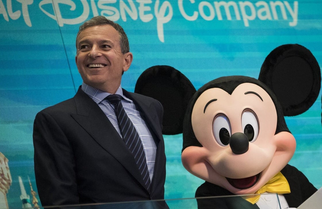 Bob Iger and Mickey Mouse look on before ringing the opening bell at the New York Stock Exchange.