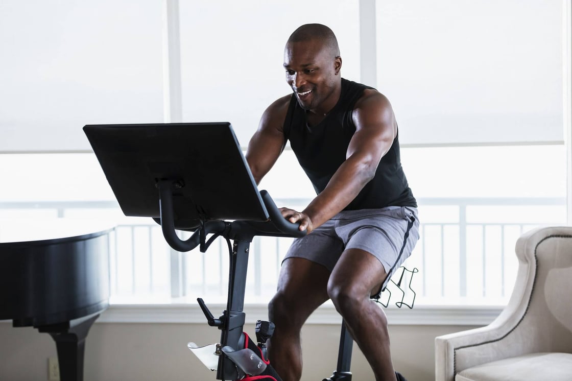 A man biking on a stationary bike.