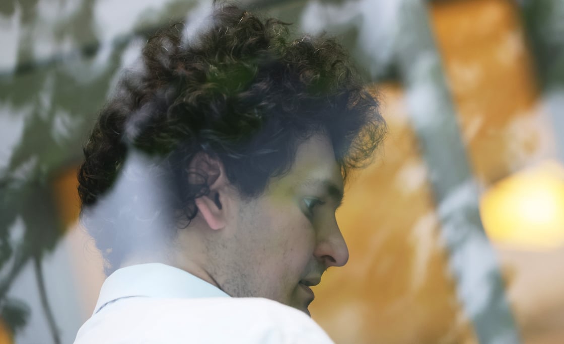 Sam Bankman-Fried viewed through glass at a bail hearing.