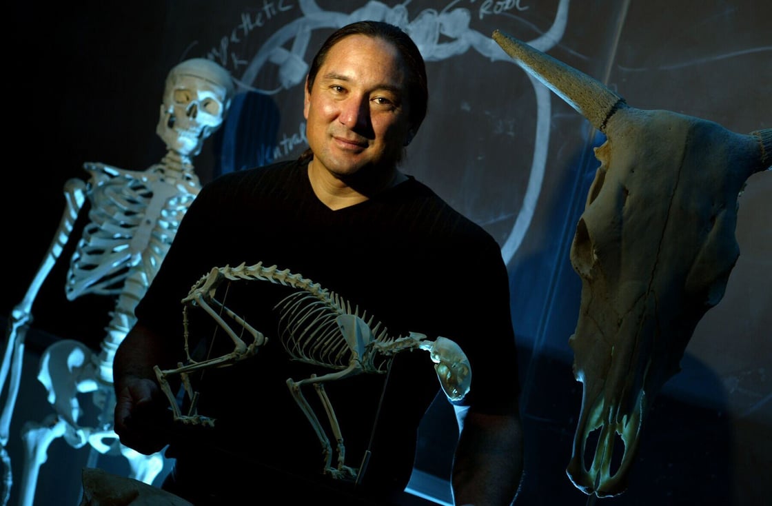 Stuart Sumida holding a fossil