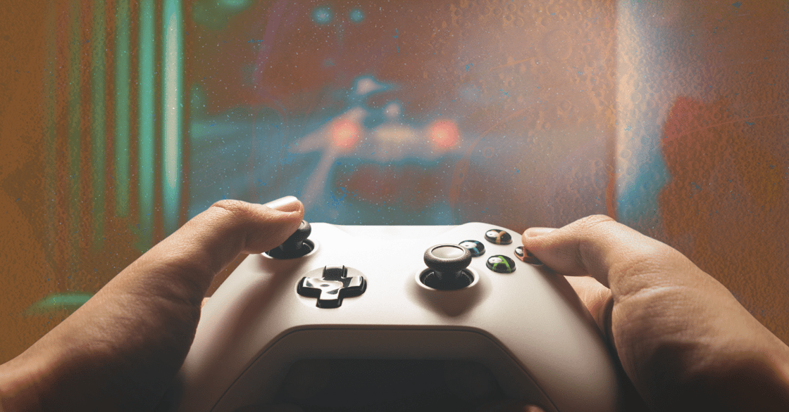 Two hands holding a video game controller.