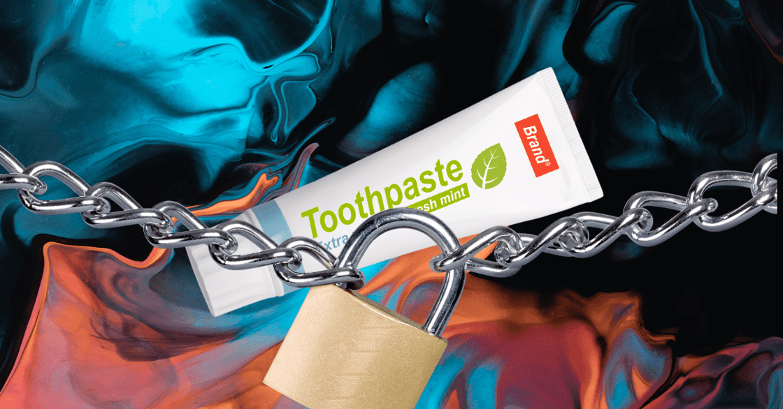 A tube of toothpaste behind a padlock.