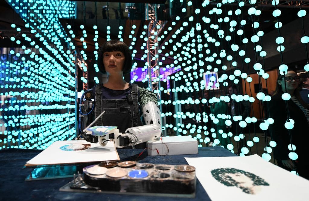 Robot artist Ai-Da draws at the 2024 Artificial Intelligence AI for Good Global Summit.