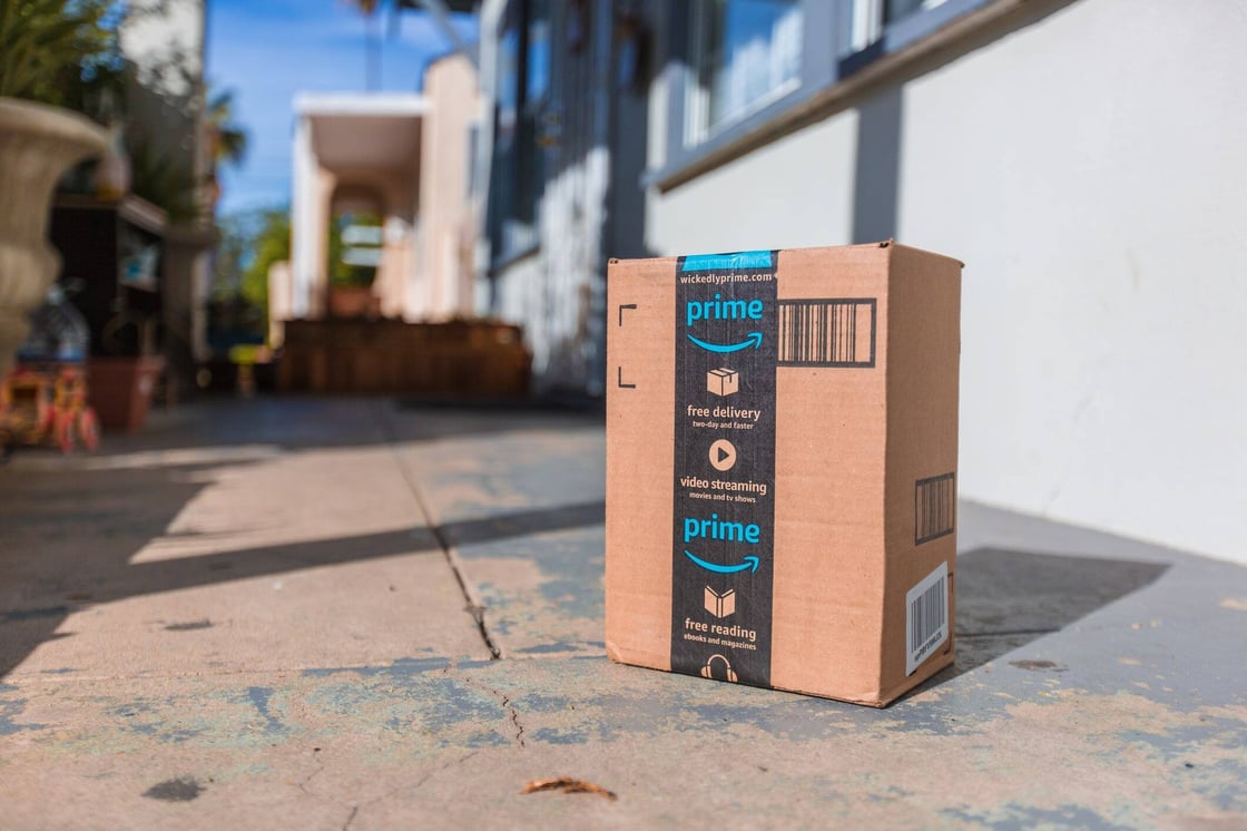 An Amazon package on a sidewalk.