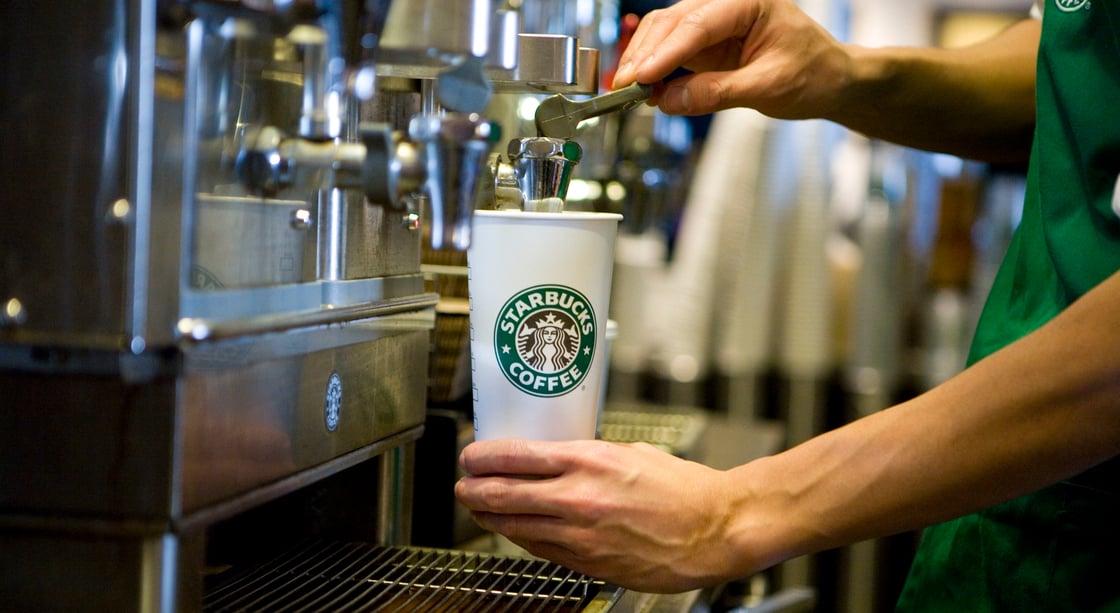 A Starbucks barista prepares a drink.