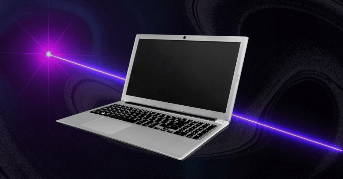 A laptop computer with a purple laser being shot through it. 