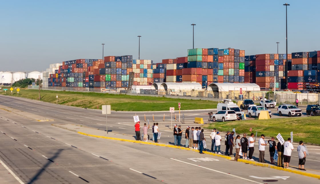 An aerial view of dockworkers standing outside of the Port of Houston Authority. 