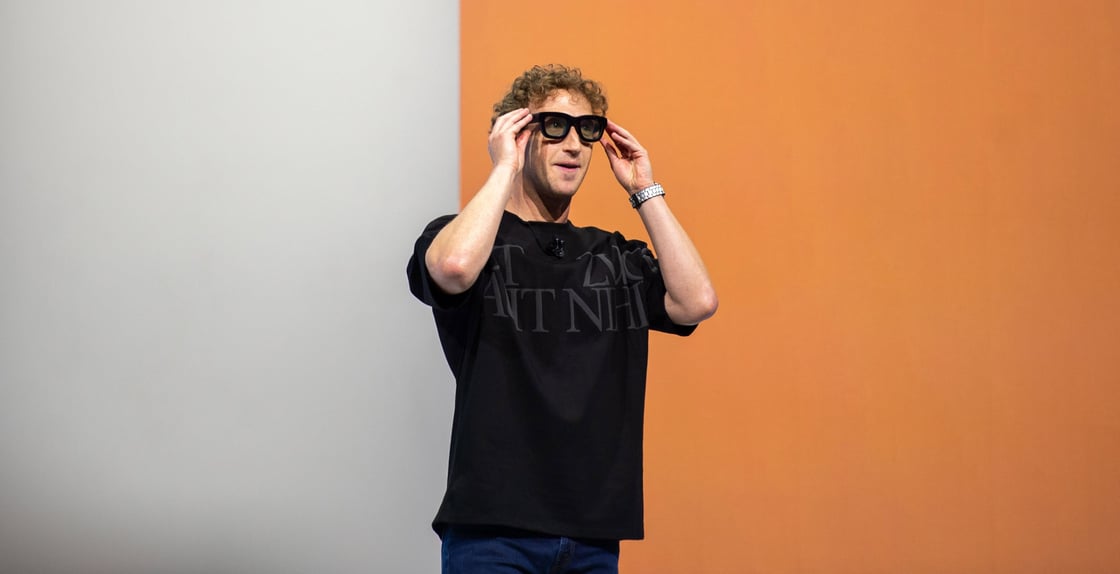 Mark Zuckerberg puts on black sunglasses.